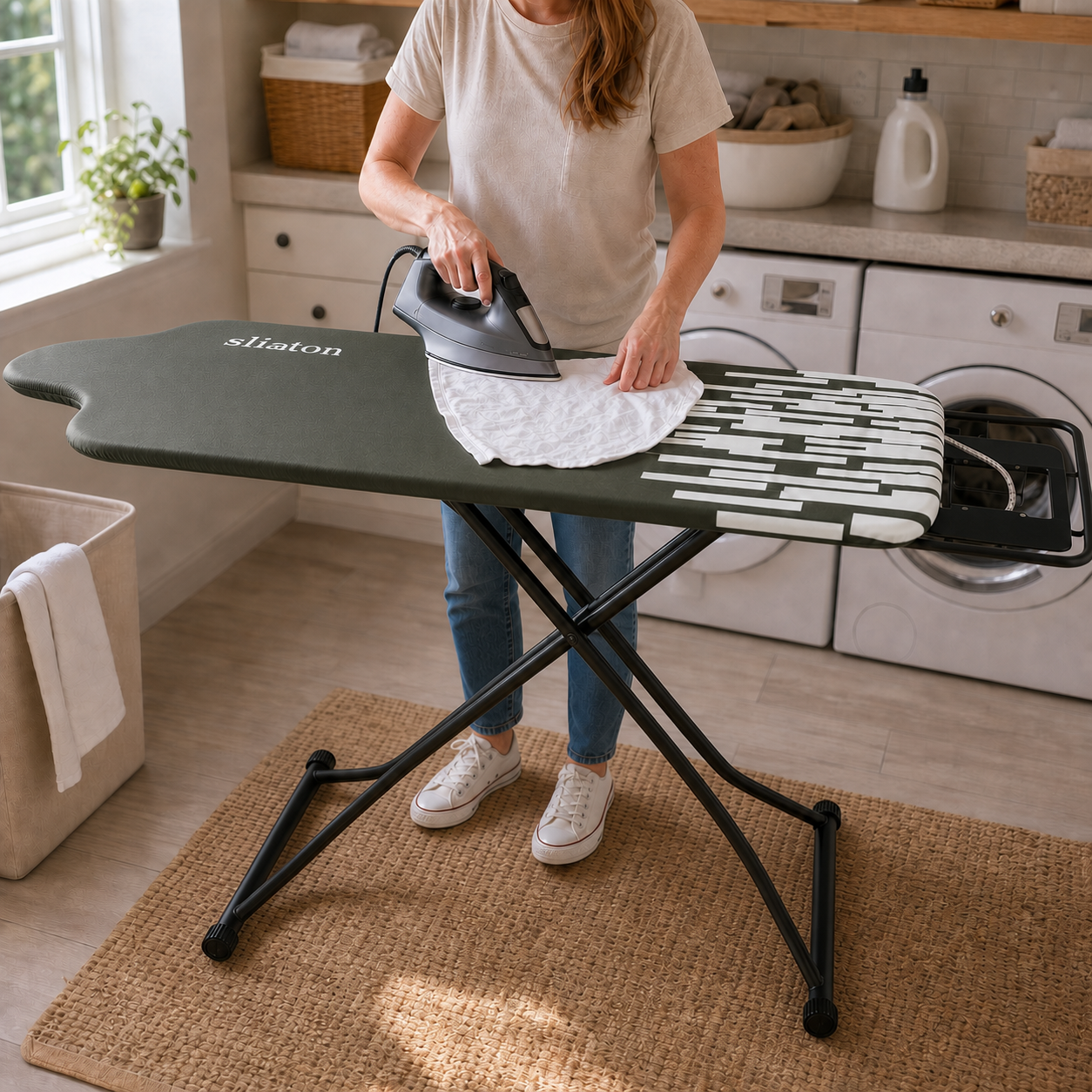 Woman using the SLIETON extra-wide ironing board in a bright laundry room